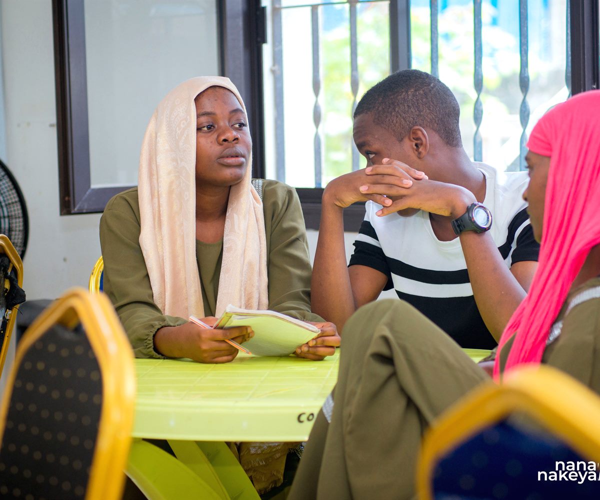 Children and mentors learning together in a community space